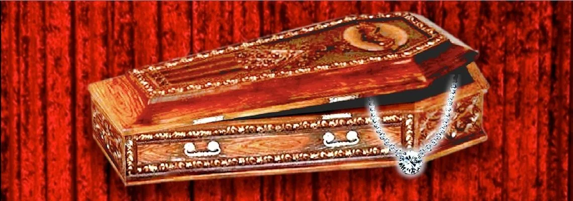 An ornate wooden coffin with a diamond necklace hanging from its lid, against a red velvet curtain