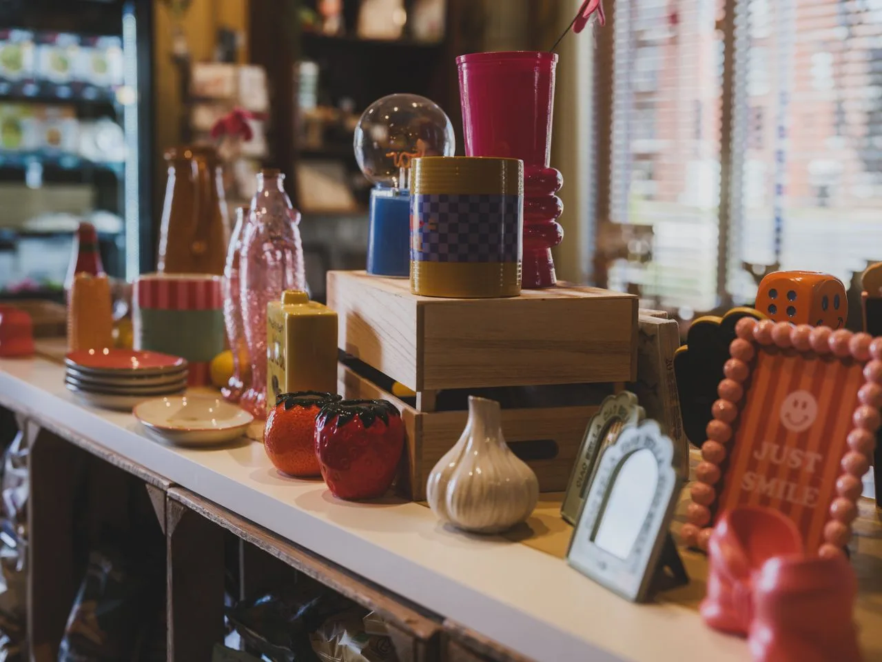 A shelf of handmade ceramics, glassware and giftware for sale at the Yarra Valley Waterwheel